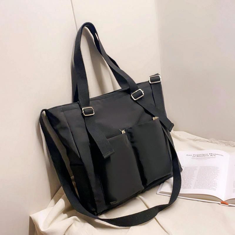 Spring new ladies Messenger bag Korean version of literature and art solid color student single shoulder bag large capacity tutoring class bag Double pocket waterproof black without pendant